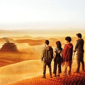 Four characters from the tv show 3% in front of the Shell, a solarpunk structure in a desert.